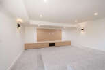 This modern living space features a built-in entertainment center with ample storage and a sleek design.
