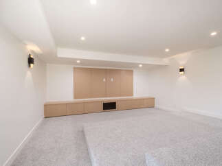 This modern living space features a built-in entertainment center with ample storage and a sleek design.