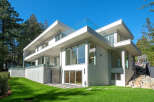 This stunning modern home boasts sleek lines and expansive windows, offering a seamless blend of indoor and outdoor living.