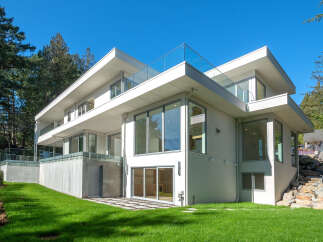 This stunning modern home boasts sleek lines and expansive windows, offering a seamless blend of indoor and outdoor living.