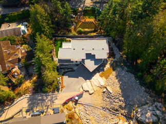 Discover a stunning modern home nestled in a serene, tree-lined setting.