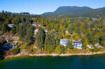 Luxury waterfront homes nestled along the scenic coastline offer breathtaking views and unparalleled privacy.