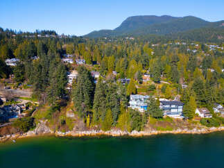 Luxury waterfront homes nestled along the scenic coastline offer breathtaking views and unparalleled privacy.