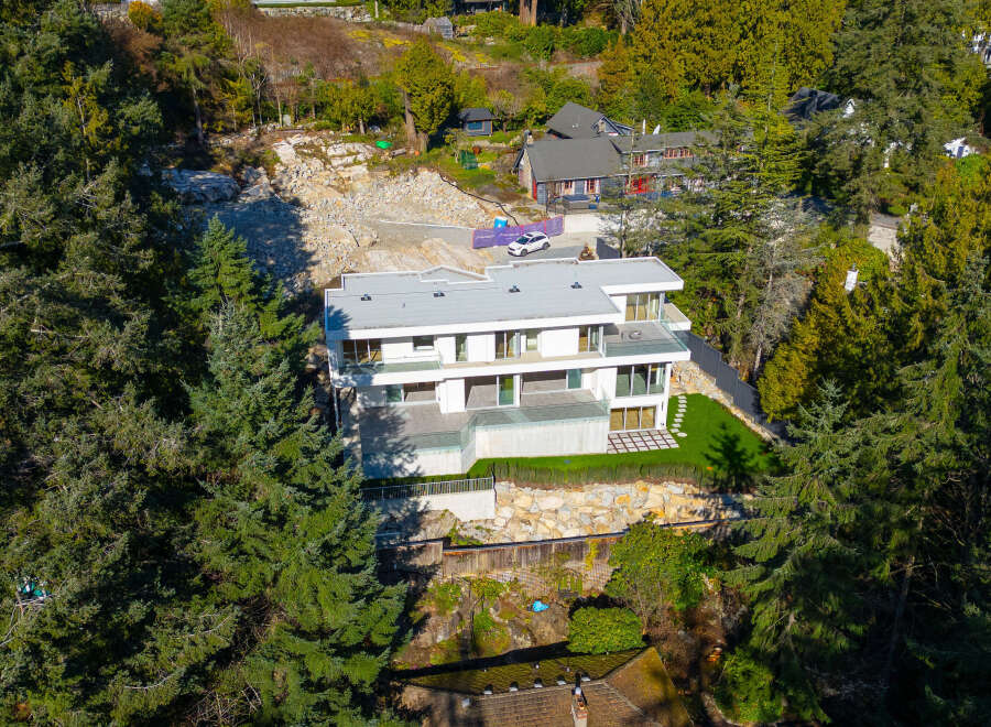 This stunning modern home offers a luxurious living experience with its sleek design and expansive views.
