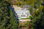 This stunning modern home offers a luxurious living experience with its sleek design and expansive views.