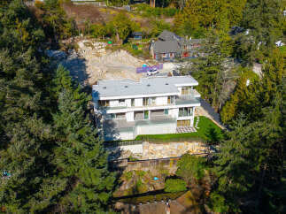 This stunning modern home offers a luxurious living experience with its sleek design and expansive views.
