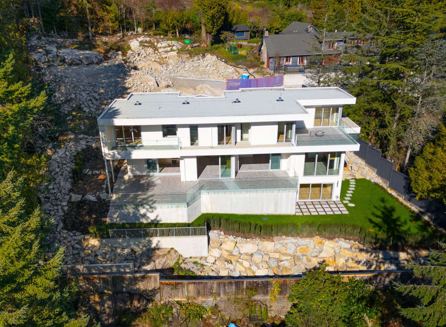 This stunning modern home offers a luxurious living experience with its sleek design and expansive views.