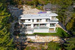 This stunning modern home offers a luxurious living experience with its sleek design and expansive views.