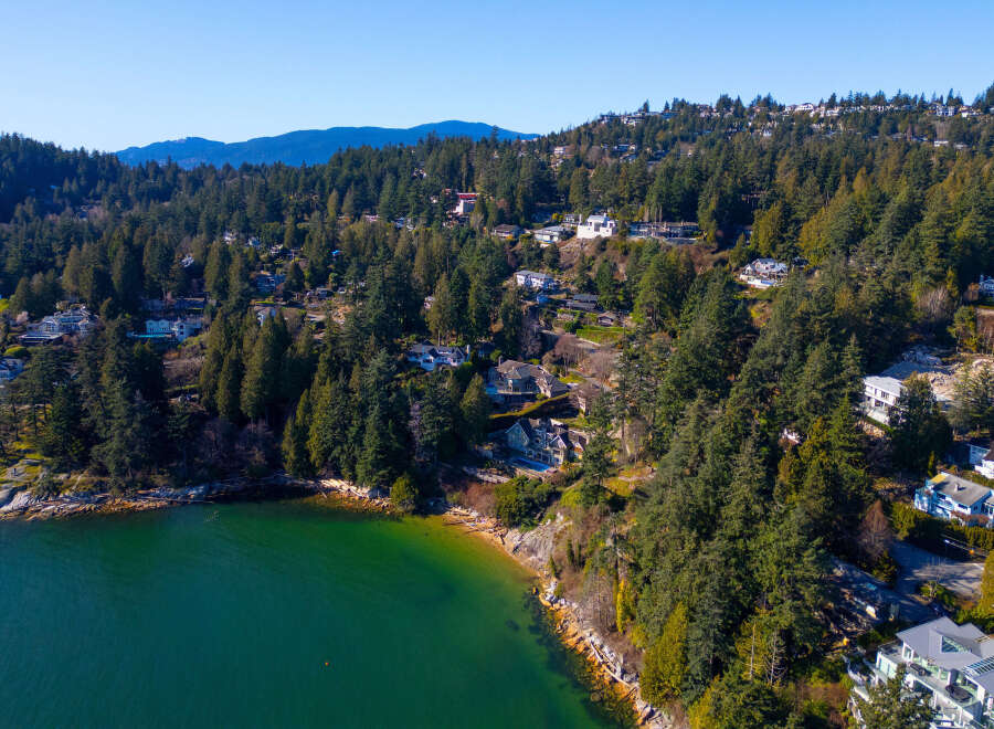 Discover luxury living in this stunning waterfront property, nestled amidst lush greenery and offering breathtaking ocean views.