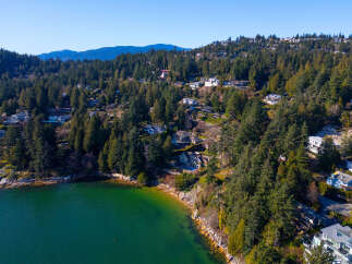 Discover luxury living in this stunning waterfront property, nestled amidst lush greenery and offering breathtaking ocean views.