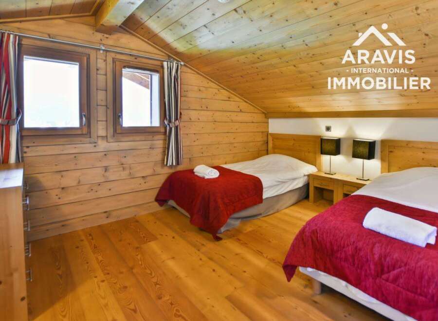 Discover a cozy bedroom retreat featuring natural wood paneling and a warm, inviting atmosphere.