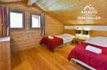 Discover a cozy bedroom retreat featuring natural wood paneling and a warm, inviting atmosphere.