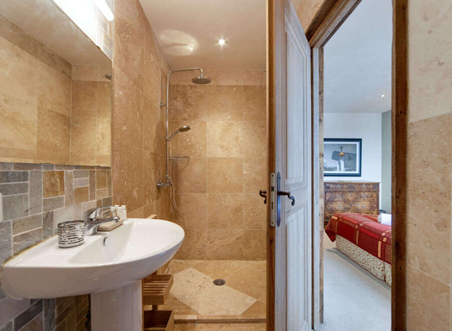 Step into luxury with this stunning bathroom featuring a modern shower and elegant sink.