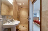 Step into luxury with this stunning bathroom featuring a modern shower and elegant sink.