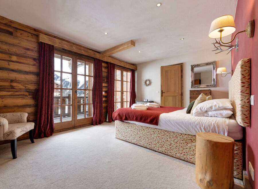 This stunning bedroom boasts a rustic charm with its wooden accents and cozy ambiance.