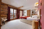 This stunning bedroom boasts a rustic charm with its wooden accents and cozy ambiance.