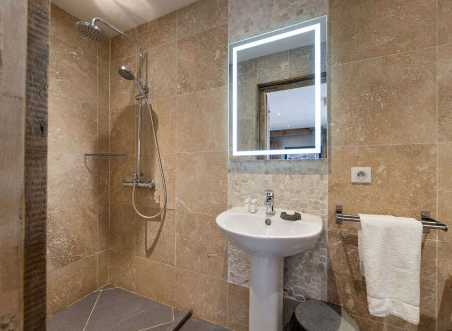 This stunning bathroom features a modern design with a walk-in shower and a stylish pedestal sink.