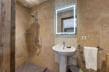 This stunning bathroom features a modern design with a walk-in shower and a stylish pedestal sink.