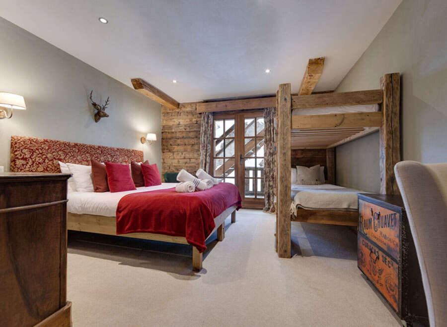 This cozy bedroom features a rustic design with wooden accents and a comfortable bed.