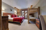 This cozy bedroom features a rustic design with wooden accents and a comfortable bed.