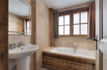 This stunning bathroom boasts a rustic charm with its wooden accents and natural stone tiles.