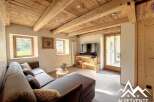 Discover the charm of this stunning property, featuring a cozy living room with a rustic wooden ceiling and a comfortable sofa.