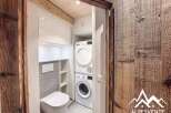 Discover this charming property featuring a modern laundry room with a stacked washer and dryer, perfect for efficient living.