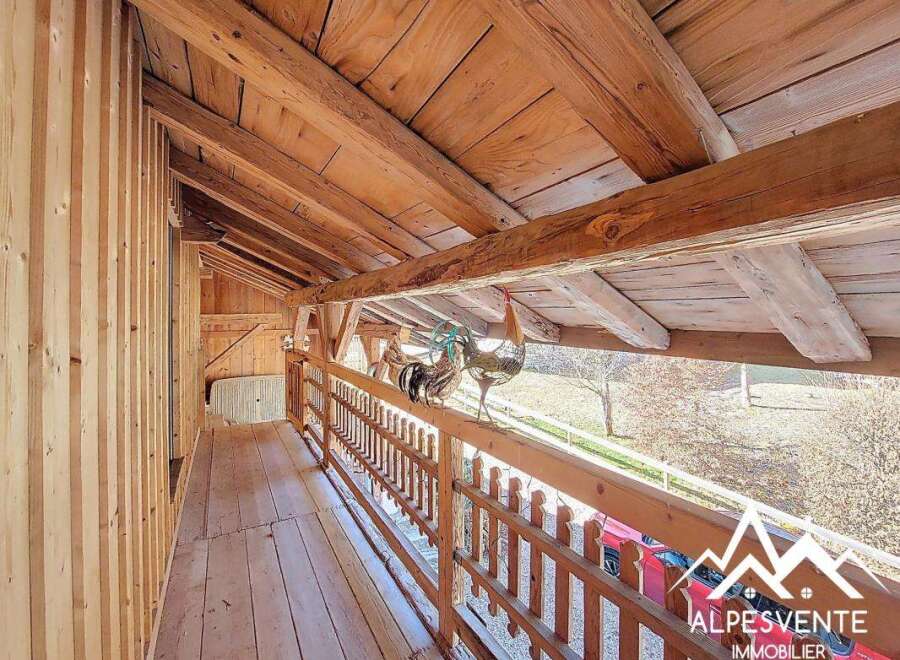 Discover the charm of this unique property, showcasing exquisite wooden architecture and a cozy balcony.