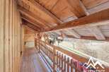 Discover the charm of this unique property, showcasing exquisite wooden architecture and a cozy balcony.