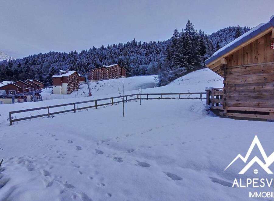 Discover a charming chalet nestled in a snowy mountain landscape, perfect for a winter getaway.