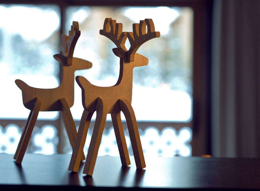 Discover the charm of this property, featuring unique wooden deer decorations that add a touch of rustic elegance.