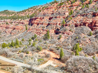 Explore the stunning natural beauty of this property, nestled against a backdrop of majestic red rock formations.