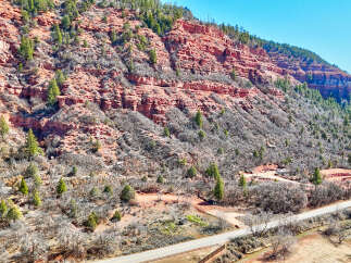 Explore the stunning natural beauty of this property, nestled against a backdrop of majestic red rock formations.