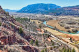 Discover a stunning piece of land with breathtaking views of the surrounding mountains and a serene river.