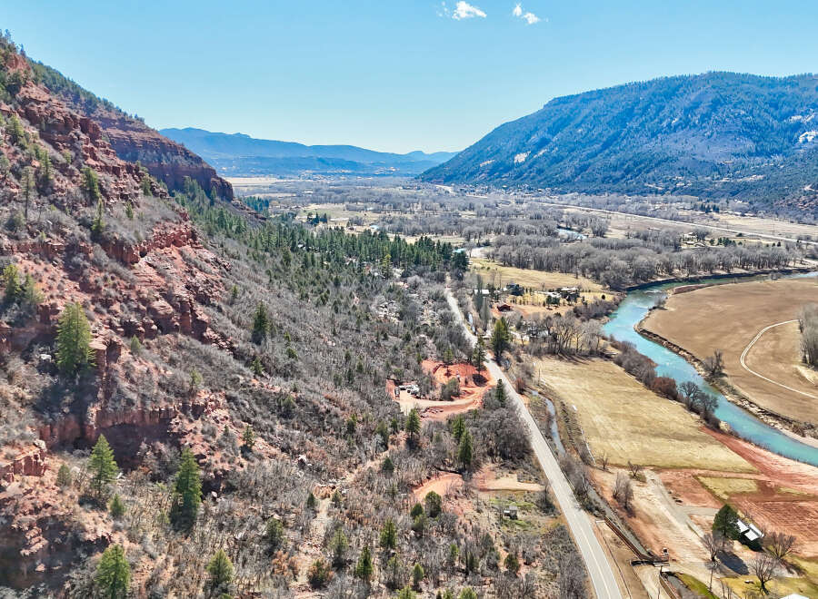 Explore the breathtaking beauty of this stunning property nestled amidst majestic mountains and a serene river.