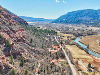 Explore the breathtaking beauty of this stunning property nestled amidst majestic mountains and a serene river.