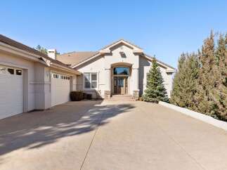 This stunning property boasts a grand entrance with a spacious driveway, perfect for welcoming guests.
