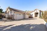 Discover luxury living in this stunning property! This home boasts a spacious driveway leading to a three-car garage, perfect for families or car enthusiasts.