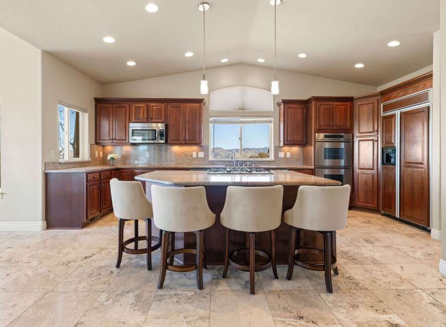 This stunning kitchen boasts rich wood cabinetry, creating a warm and inviting atmosphere.