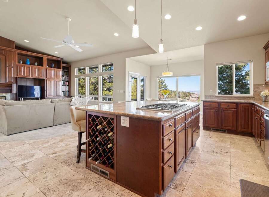 This stunning property boasts a spacious kitchen with a large island, perfect for culinary enthusiasts and entertaining guests.