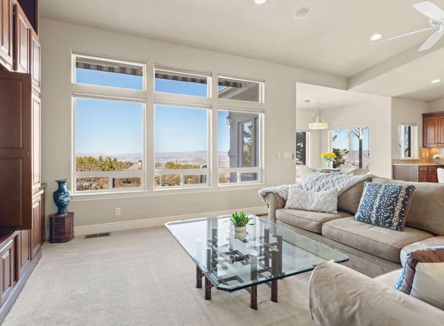 This stunning living room boasts expansive windows that frame breathtaking views.