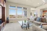 This stunning living room boasts expansive windows that frame breathtaking views.