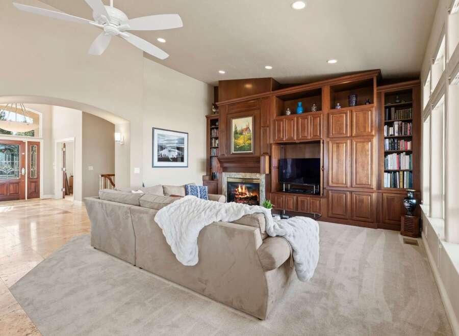 Step into luxury with this stunning property, featuring a cozy fireplace and a built-in entertainment center, perfect for relaxing evenings.