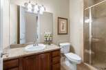Step into this beautifully designed bathroom, featuring a granite countertop and rich wooden cabinetry that exudes warmth and sophistication.