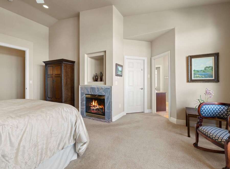 This elegant bedroom features a cozy fireplace, perfect for relaxing on chilly evenings.