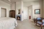 This elegant bedroom features a cozy fireplace, perfect for relaxing on chilly evenings.