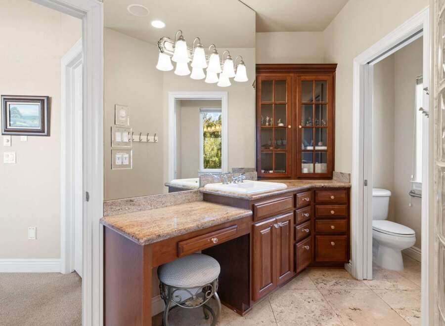 Step into luxury with this stunning bathroom featuring a custom vanity and elegant cabinetry.