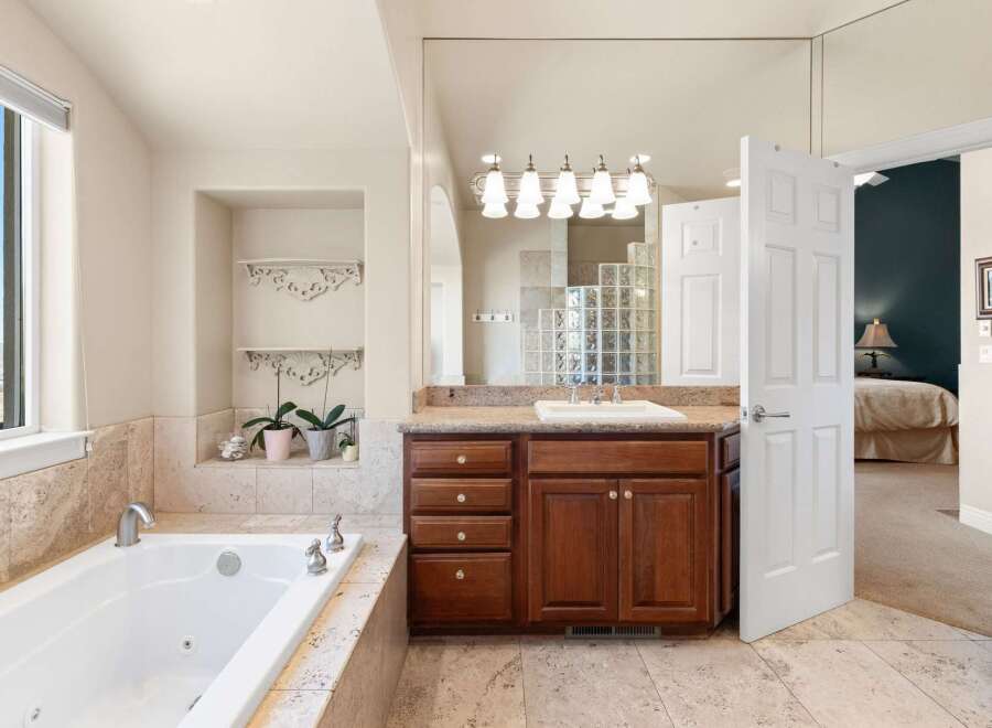 Step into luxury with this stunning bathroom! Featuring a spacious tub, elegant vanity, and ample natural light, this space is designed for relaxation.