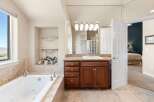 Step into luxury with this stunning bathroom! Featuring a spacious tub, elegant vanity, and ample natural light, this space is designed for relaxation.