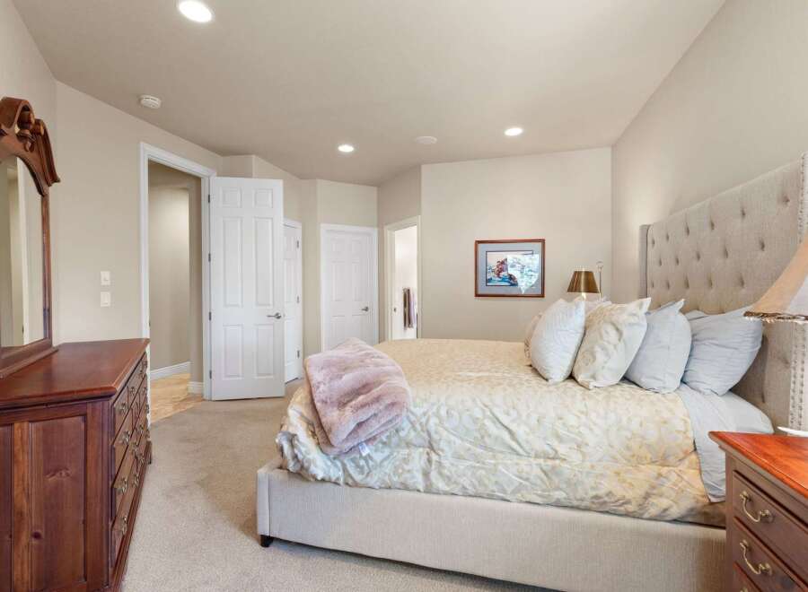 Step into this inviting bedroom, featuring a plush bed and elegant decor.